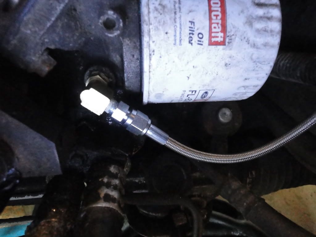 oil cooler are the big rubber hose covered of oil at the bottom left of the picture